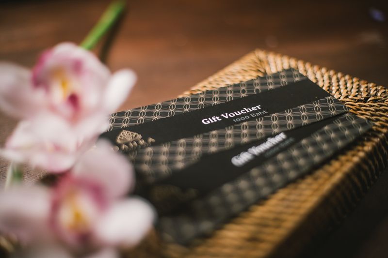 Dahra Spa gift vouchers in a rattan tray with orchids